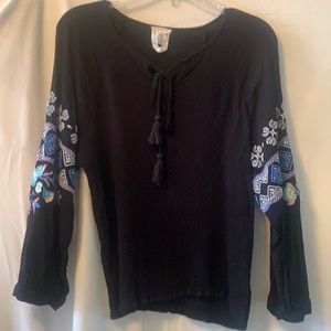 Black thin blouse with embroidered arms and tie at chest.